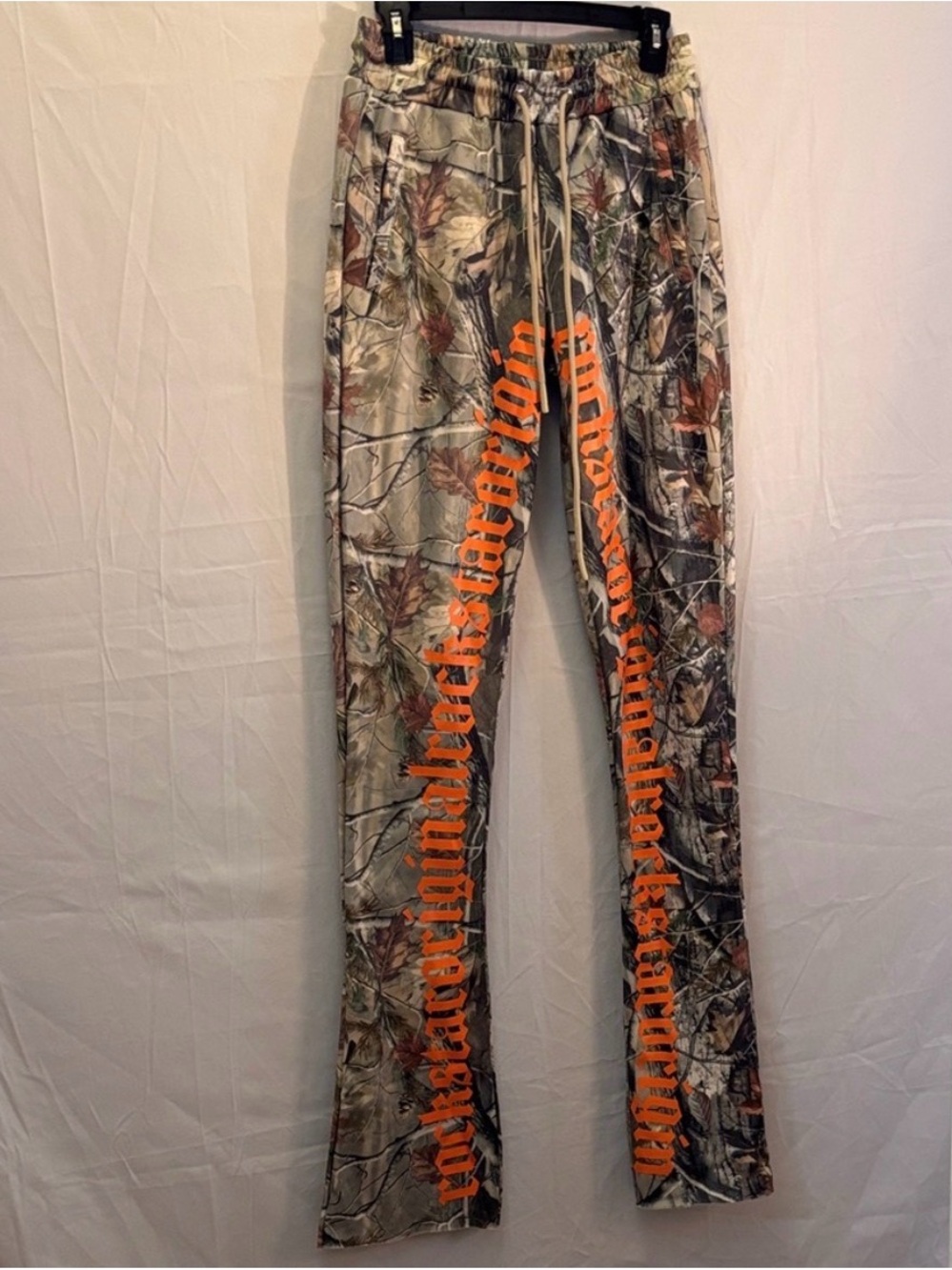 Camo pants with orange lettering